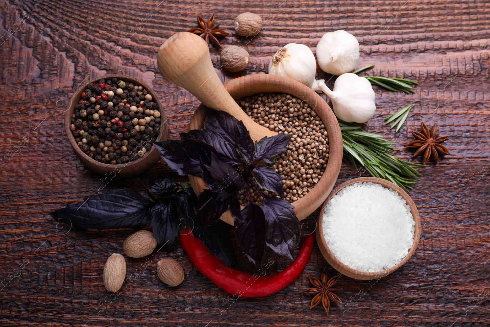 Photo of Flat lay composition with mortar and different spices on wooden table