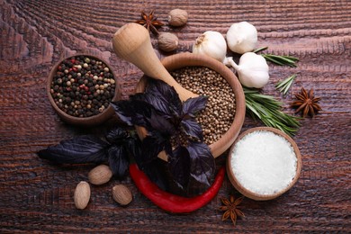 Photo of Flat lay composition with mortar and different spices on wooden table