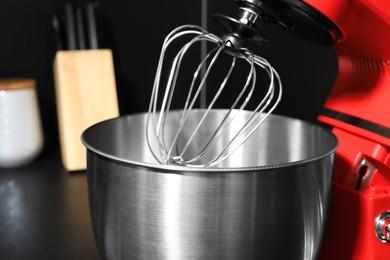 Photo of Modern stand mixer on countertop in kitchen, closeup.