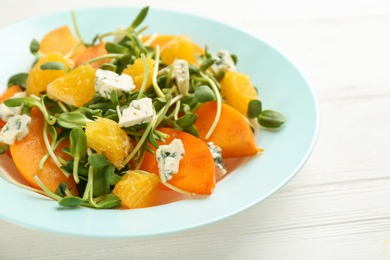 Delicious persimmon salad served on white table, closeup