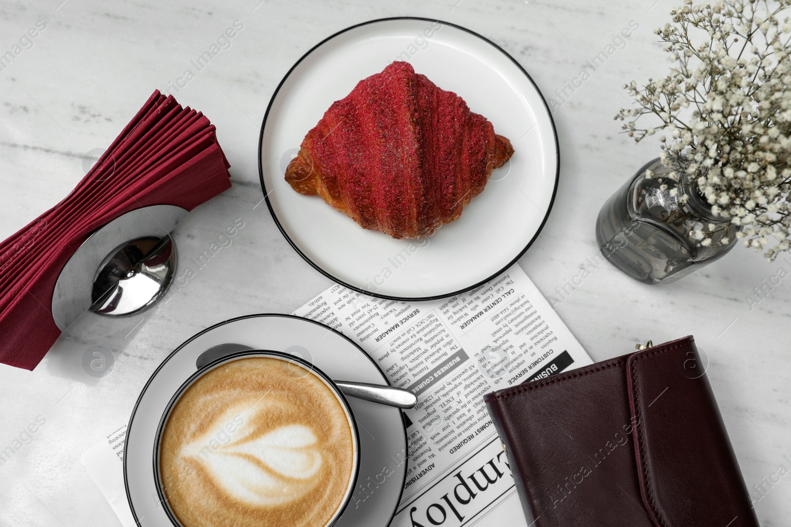 Photo of Delicious croissant and coffee on white marble table, flat lay