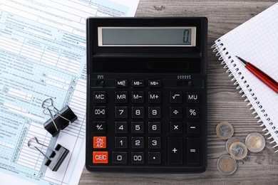 Tax accounting. Flat lay composition with calculator and document on wooden table