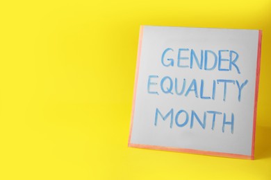 Photo of Card with phrase Gender Equality Month on yellow background, space for text