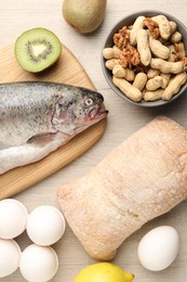 Photo of Allergenic food. Different fresh products on wooden table, flat lay