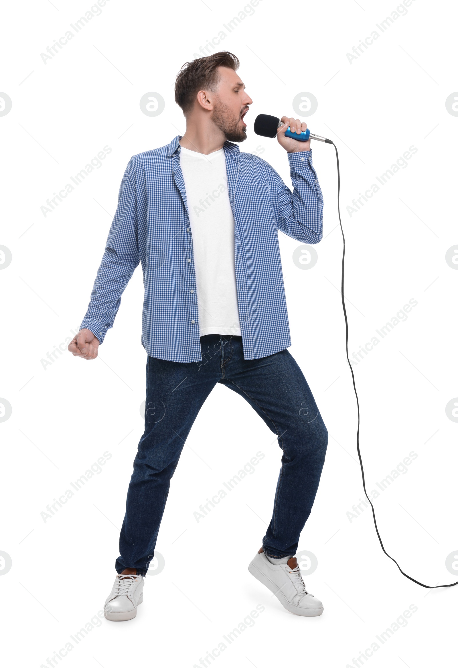 Photo of Handsome man with microphone singing on white background