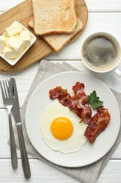 Photo of Delicious breakfast with sunny side up egg served on white wooden table, flat lay