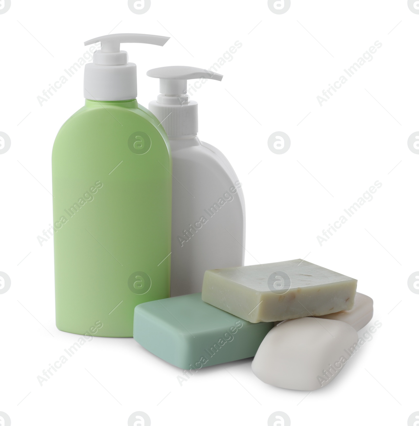 Photo of Soap bars and bottle dispensers on white background