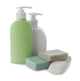 Photo of Soap bars and bottle dispensers on white background