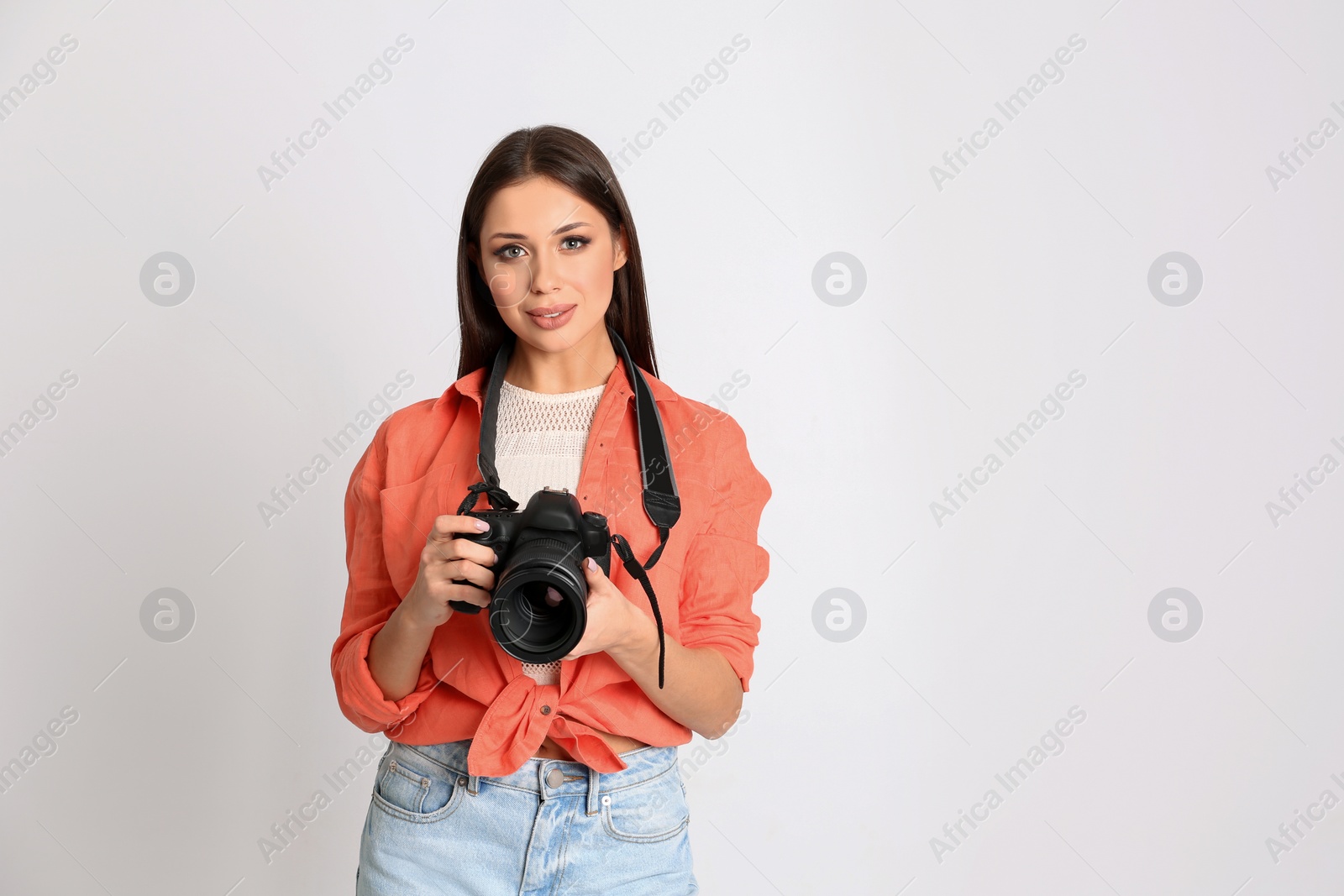 Photo of Professional photographer working on white background in studio