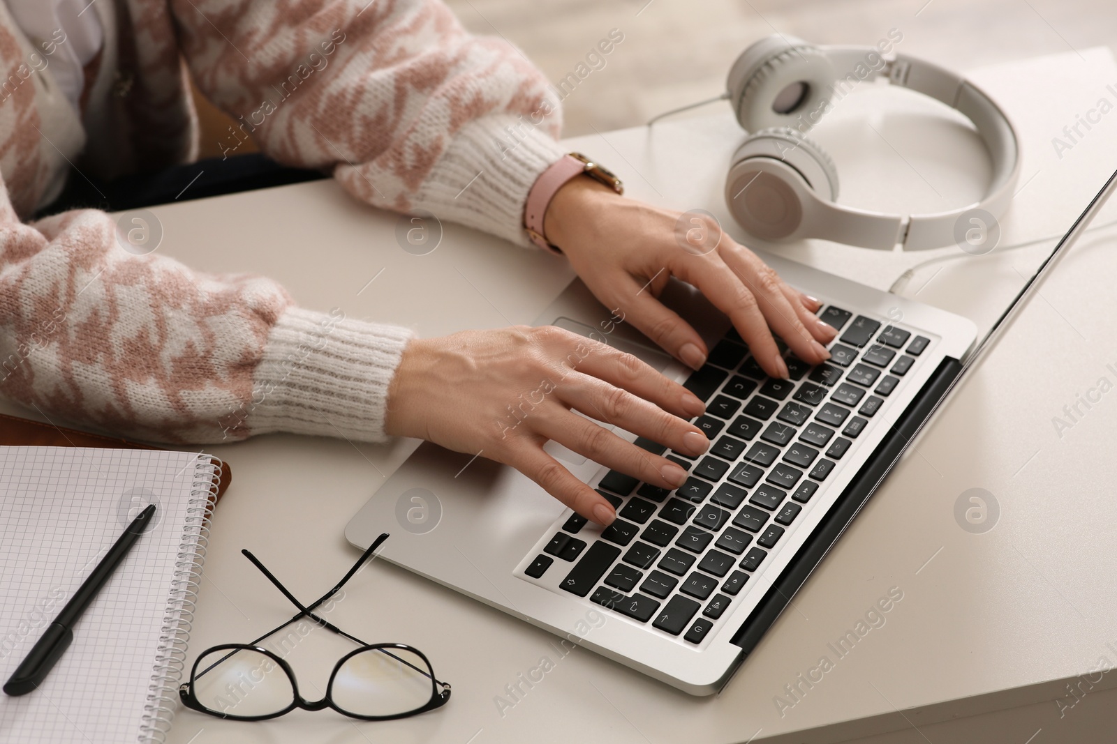 Photo of Woman with modern laptop learning at table indoors, closeup