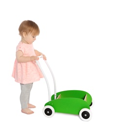 Cute baby playing with toy walker on white background