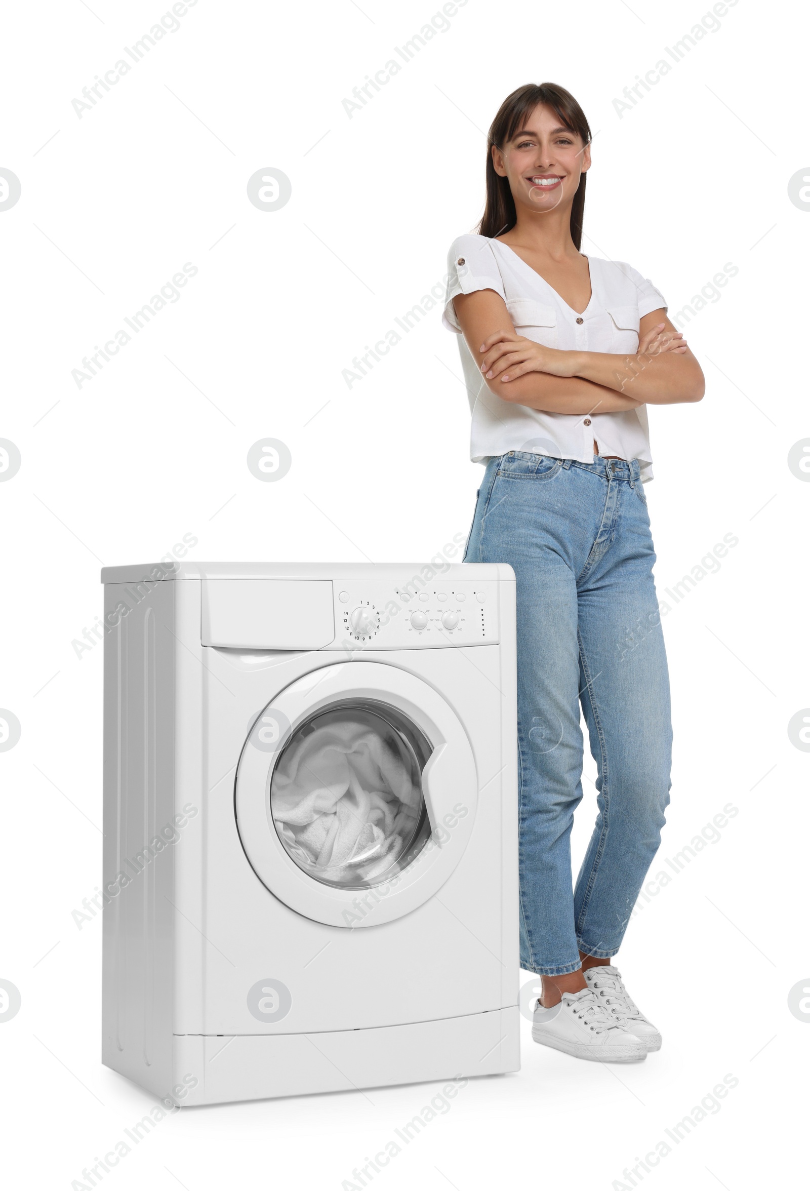 Photo of Beautiful woman near washing machine with laundry on white background