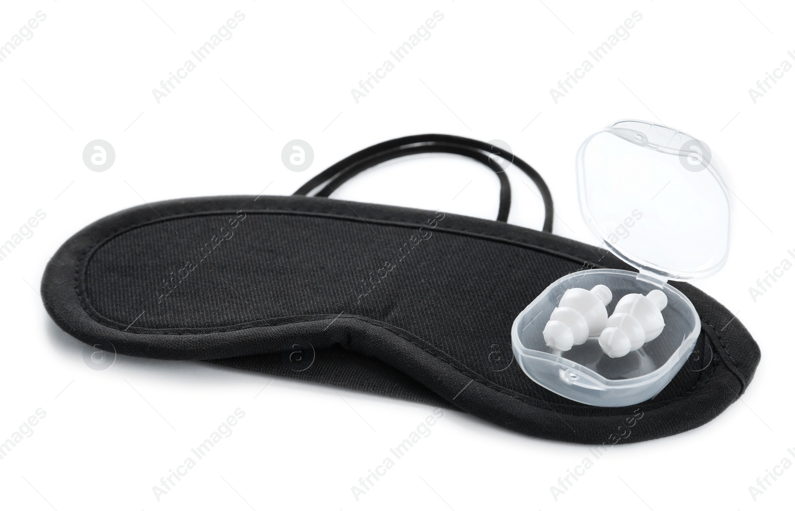 Photo of Pair of ear plugs in case and black sleeping mask on white background