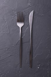 Photo of Beautiful cutlery set on black table, flat lay