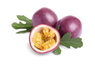 Photo of Delicious passion fruits (maracuya) and green leaves on white background