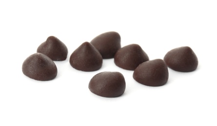 Photo of Delicious dark chocolate chips on white background