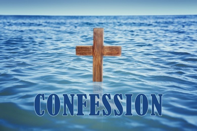 Image of Word Confession near wooden Christian cross in water