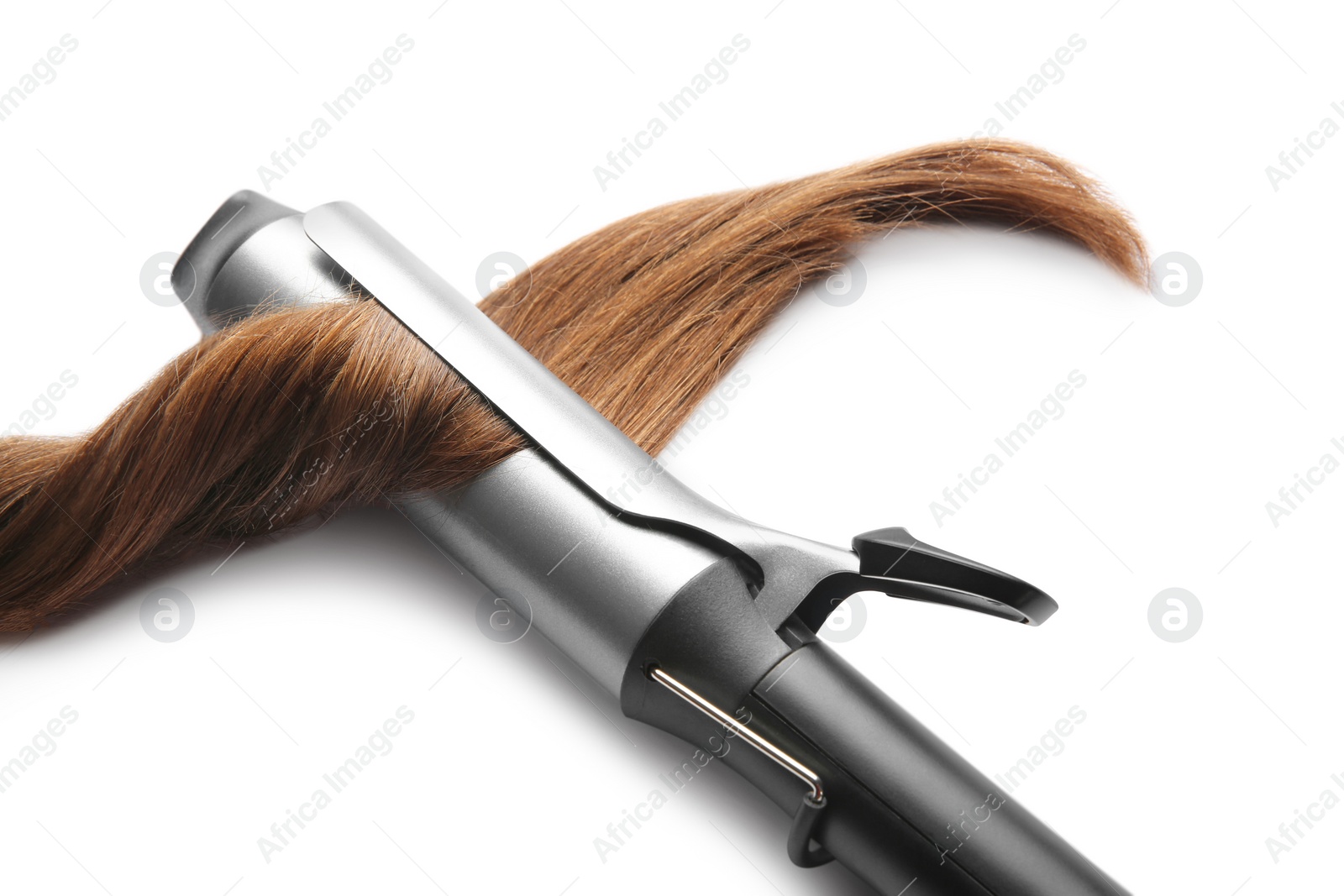 Photo of Curling iron with brown hair lock isolated on white
