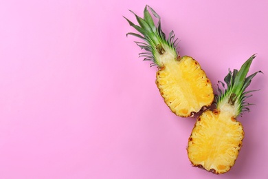 Photo of Fresh pineapple halves on color background