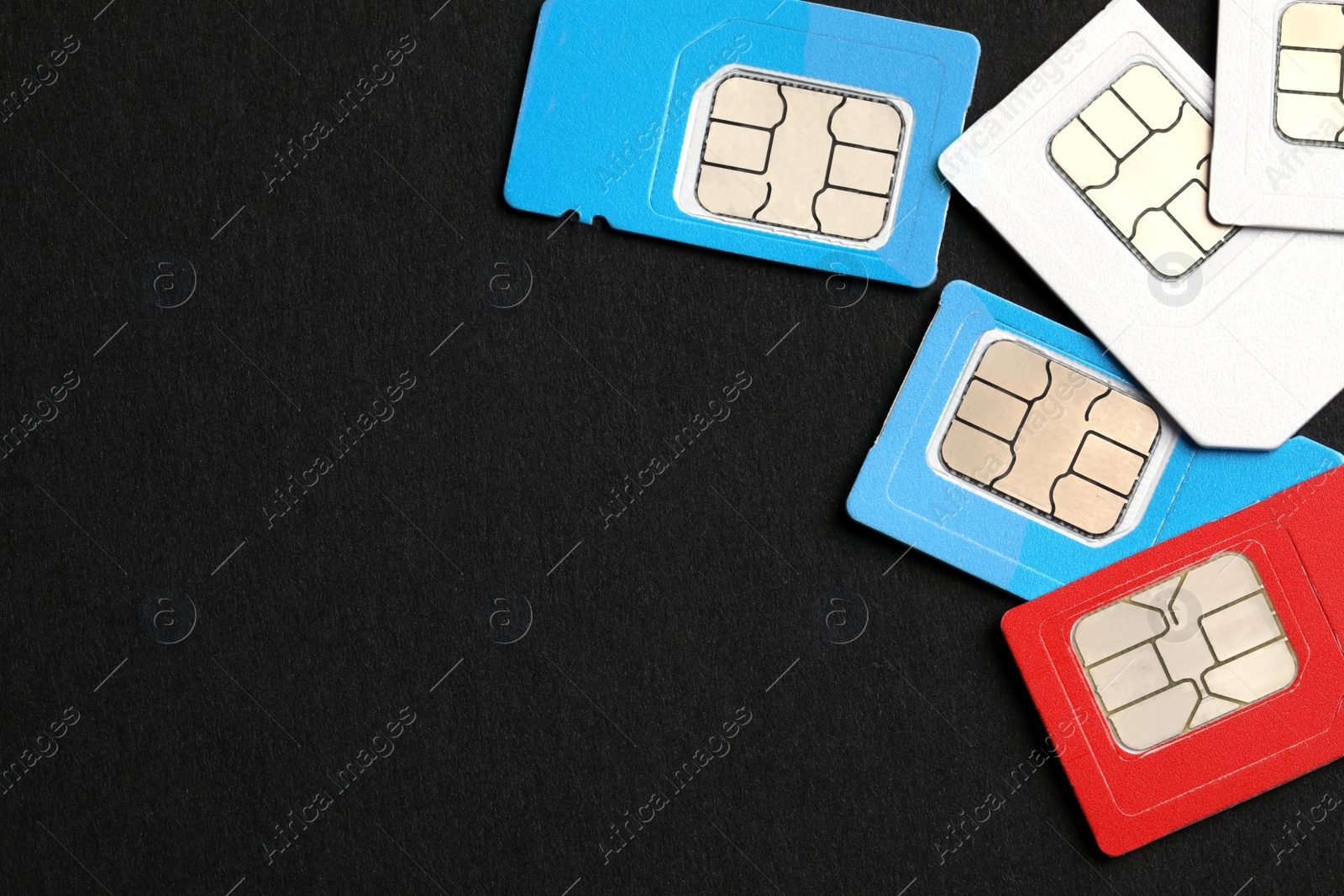 Photo of Different SIM cards on black background, flat lay. Space for text