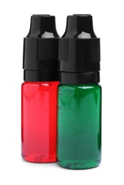 Photo of Bottles with different food coloring on white background