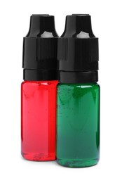 Bottles with different food coloring on white background