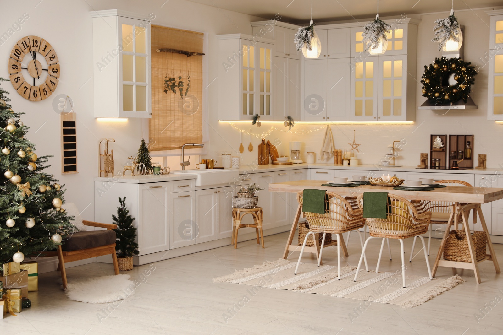 Photo of Cozy open plan kitchen decorated for Christmas. Interior design