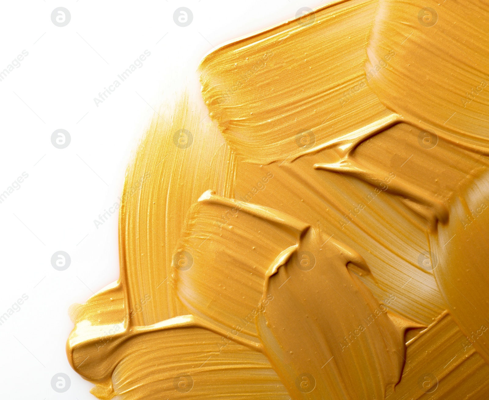 Photo of Strokes of gold paint isolated on white, top view