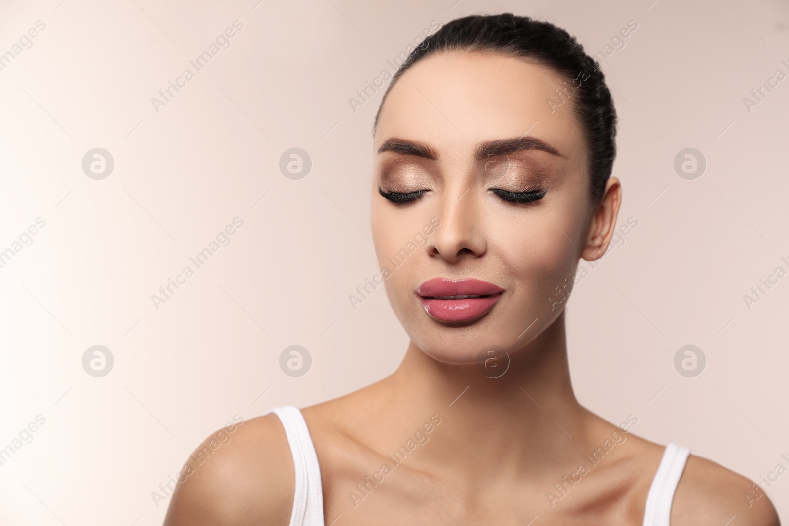 Photo of Beautiful woman with pink lipstick on light background