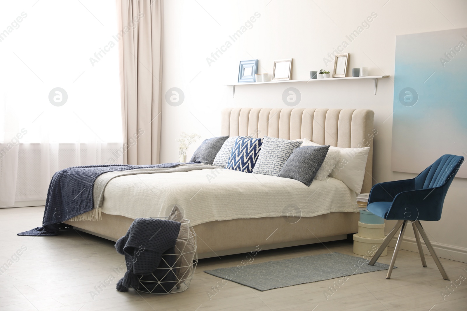 Photo of Comfortable bed with pillows in room. Stylish interior design