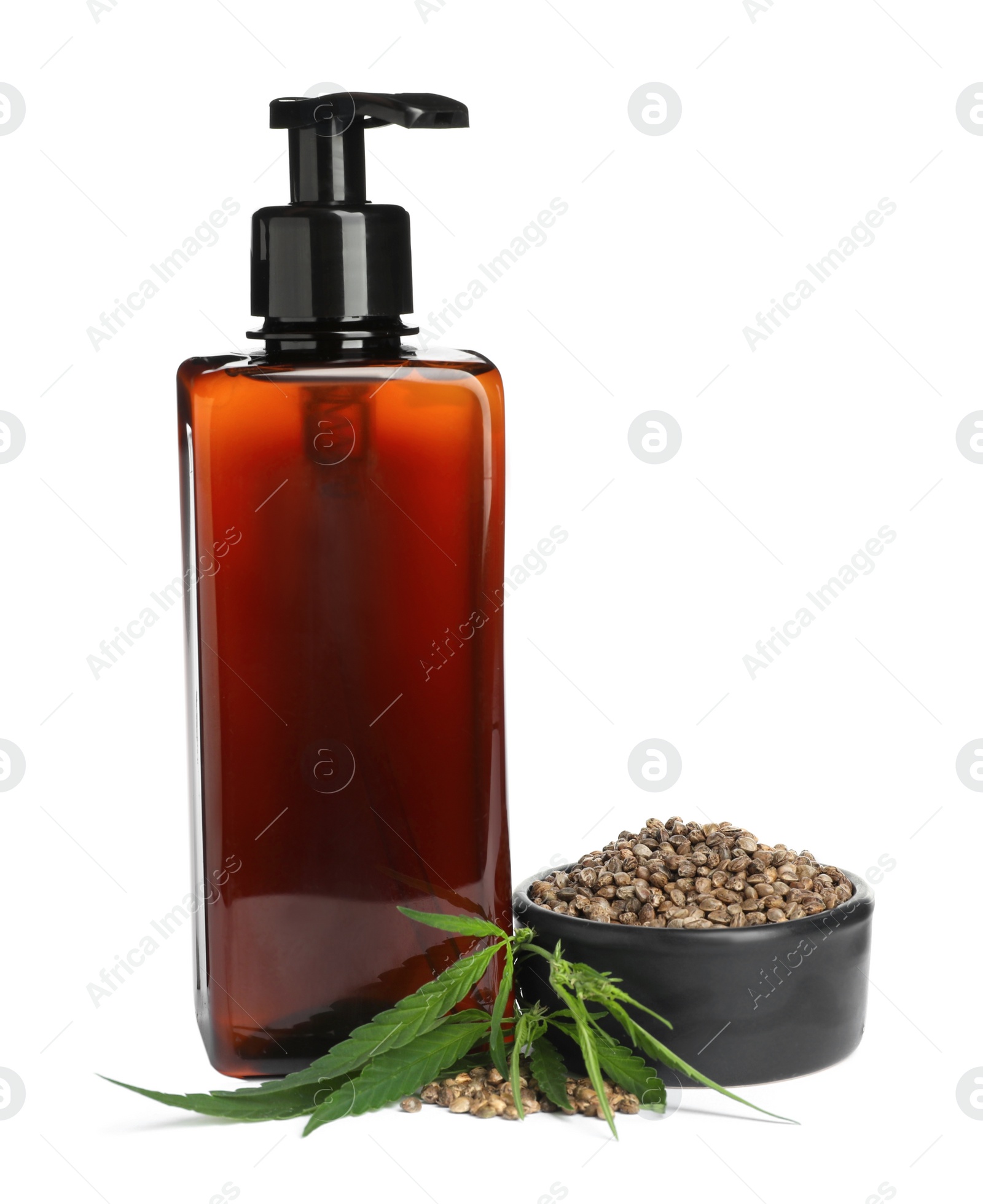 Photo of Bottle of hemp cosmetics with green leaves and seeds isolated on white