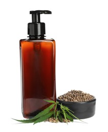 Photo of Bottle of hemp cosmetics with green leaves and seeds isolated on white