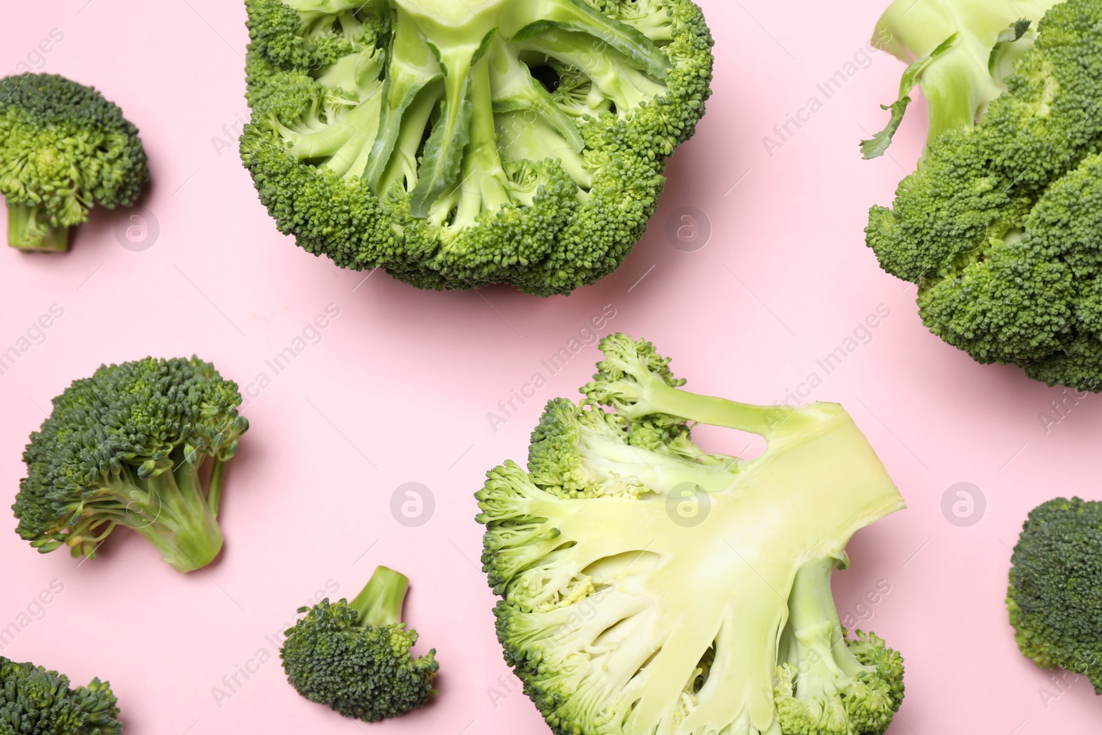 Photo of Fresh broccoli on pink background, flat lay