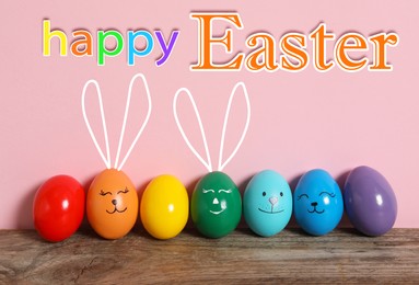Image of Happy Easter. Two eggs with drawn faces and ears as bunnies among others on wooden table against pink background