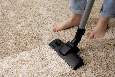 Image of Woman hoovering carpet with vacuum cleaner, closeup and space for text. Clean trace on dirty surface