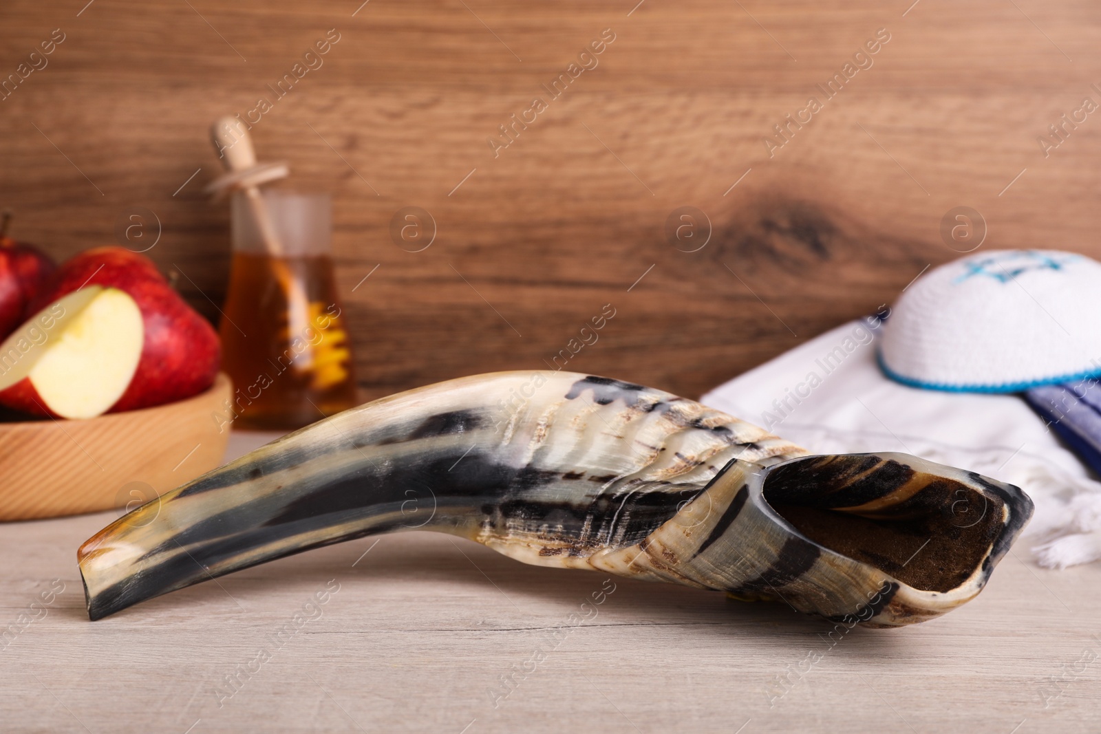 Photo of Shofar and other Rosh Hashanah holiday attributes on wooden table