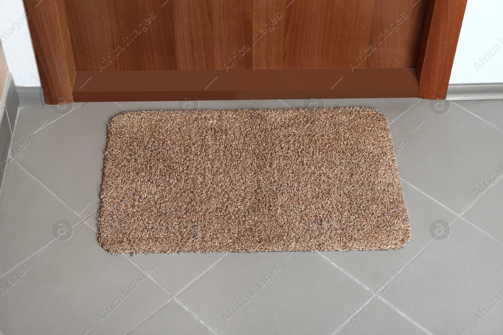 Photo of Clean door mat on floor near entrance, above view