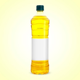 Image of Cooking oil in plastic bottle with empty label on light yellow background. Mockup for design