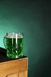 St. Patrick's day celebration. Green beer on wooden table. Space for text