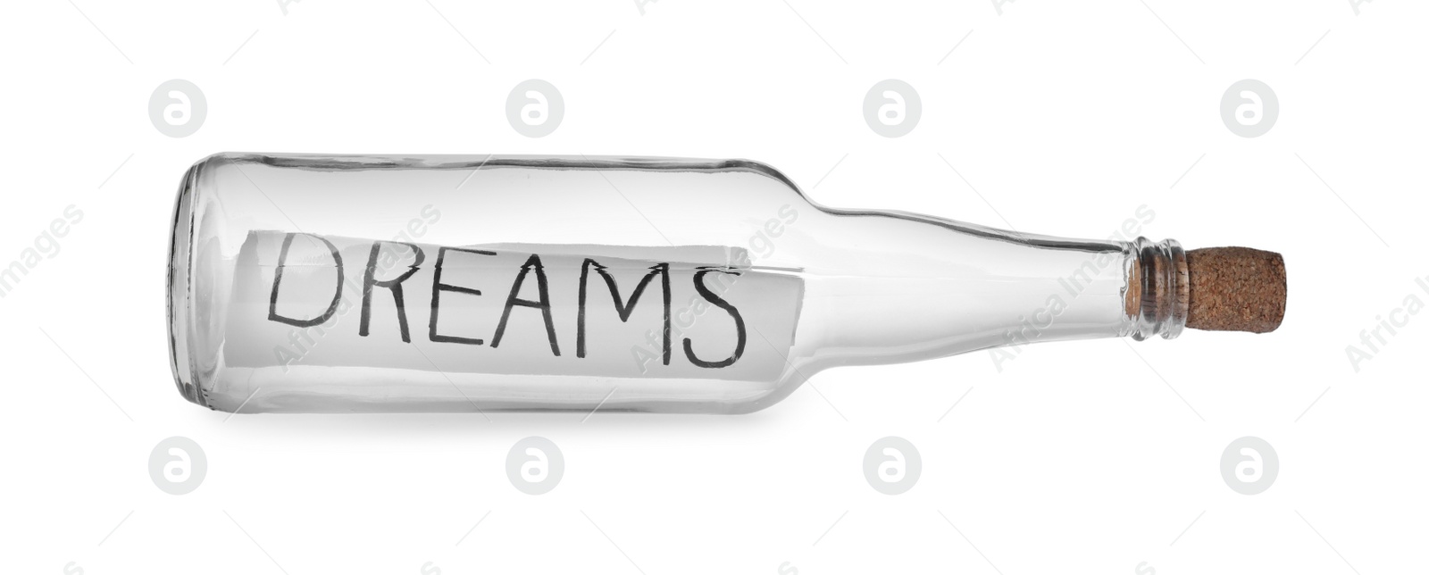 Photo of Corked glass bottle with Dreams note on white background