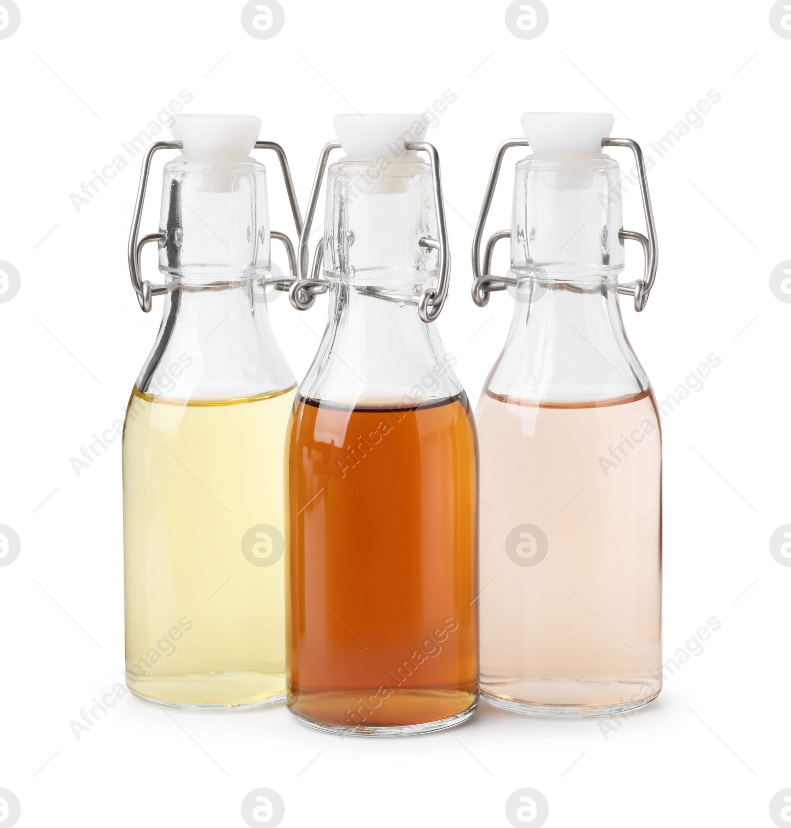 Photo of Different types of vinegar in bottles isolated on white