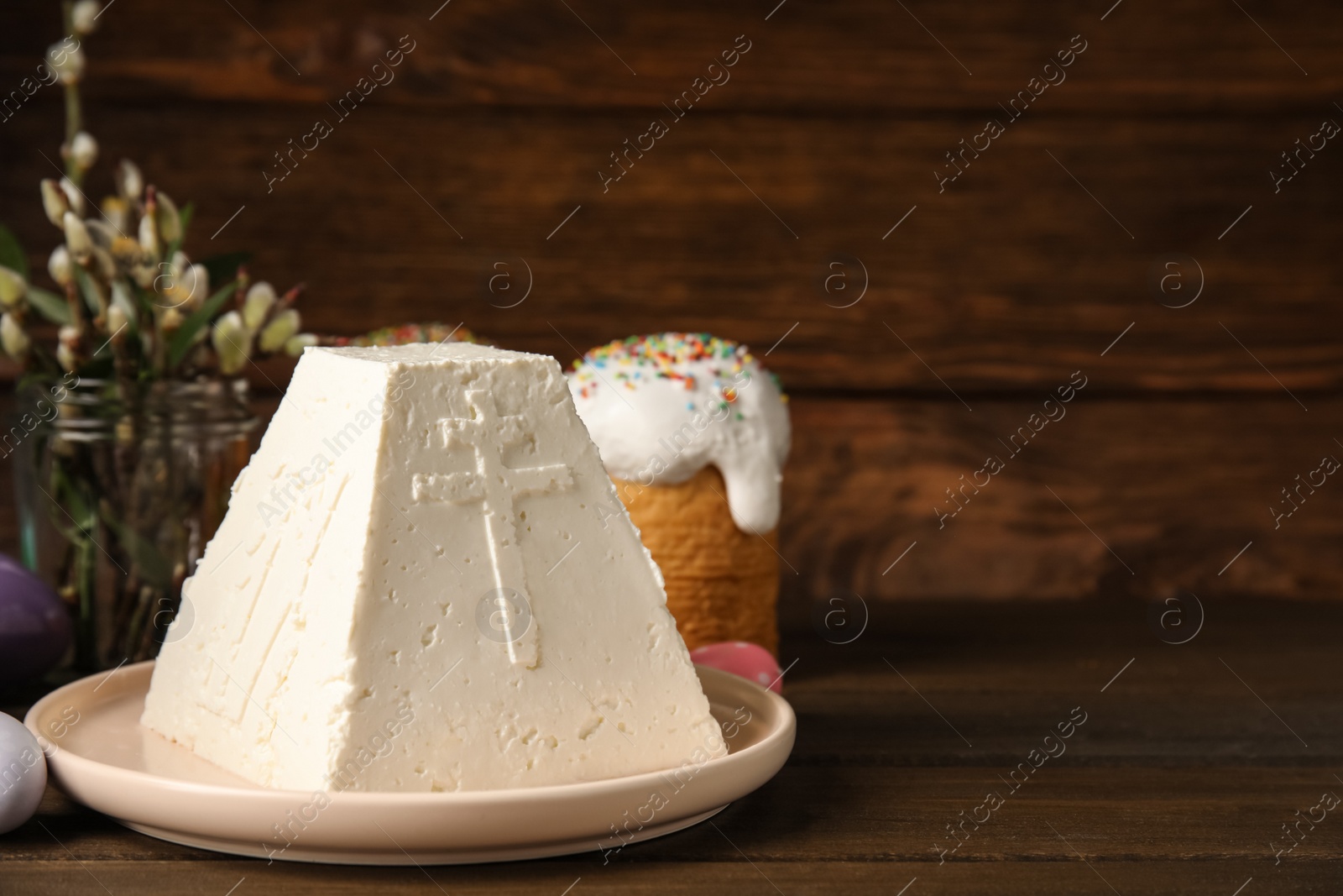 Photo of Traditional cottage cheese Easter paskha on wooden table, space for text