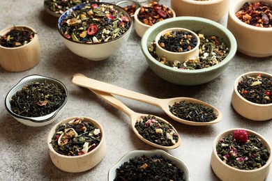 Photo of Many different herbal teas on grey table