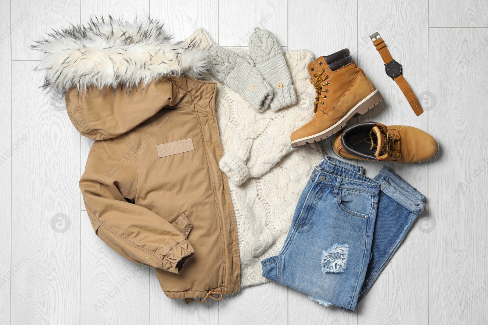 Photo of Flat lay composition with winter clothes and boots on white wooden background