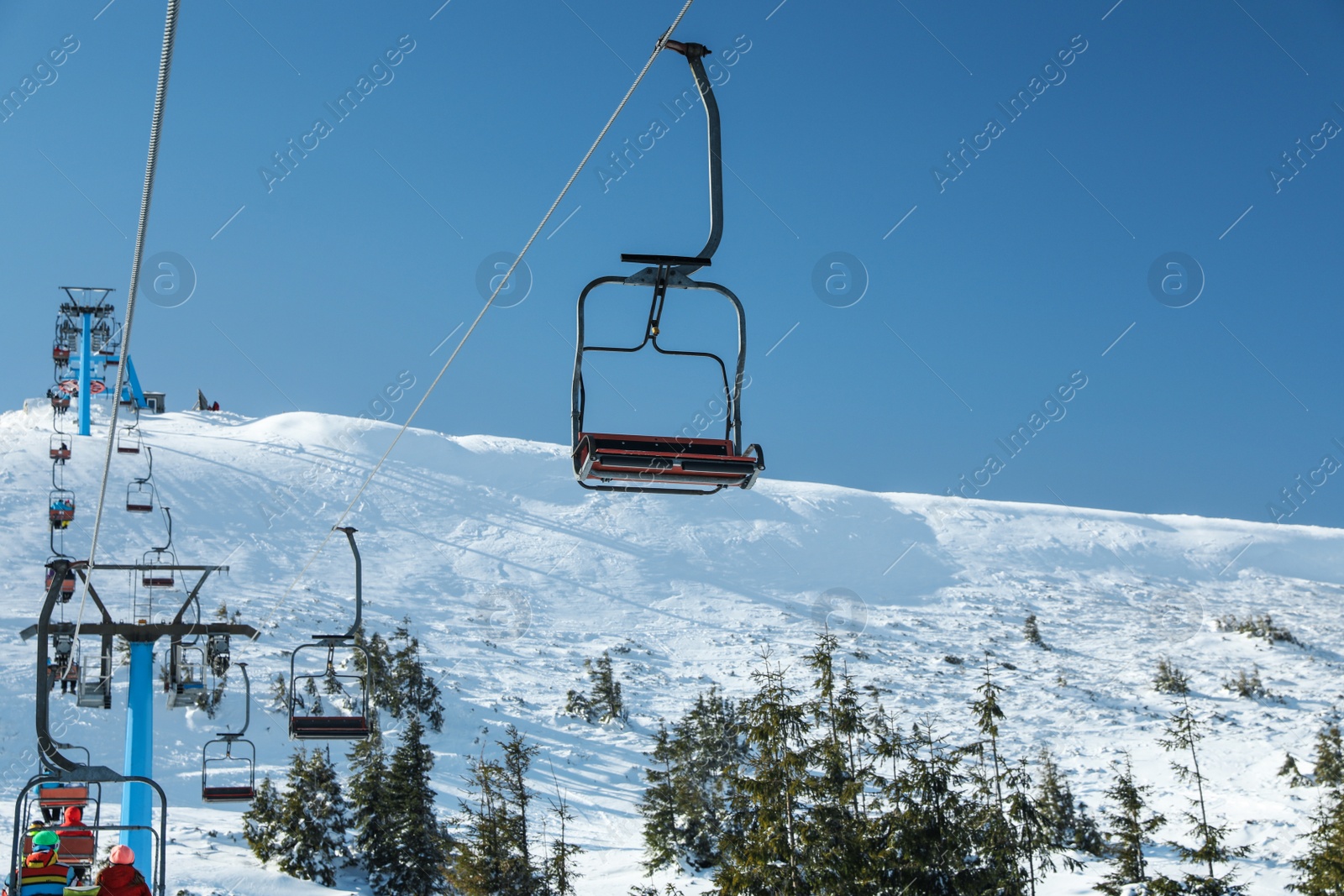 Photo of Ski lift at mountain resort. Winter vacation