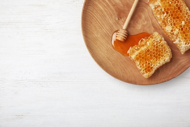 Photo of Flat lay composition with fresh honeycombs and dipper on wooden background