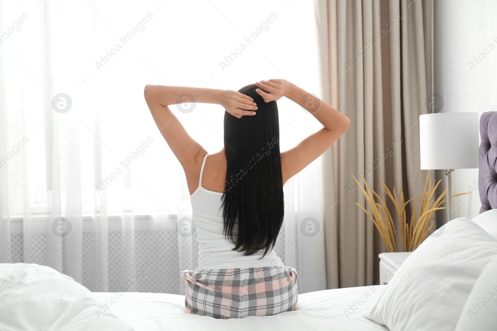 Photo of Young woman awakening at home. Lazy morning