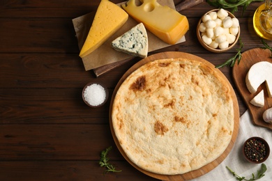 Photo of Flat lay composition with pizza crust and fresh ingredients on wooden table
