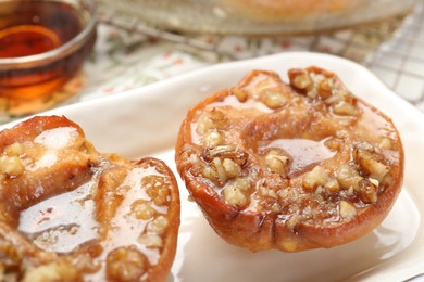 Delicious quinces baked with honey and walnuts on table, closeup