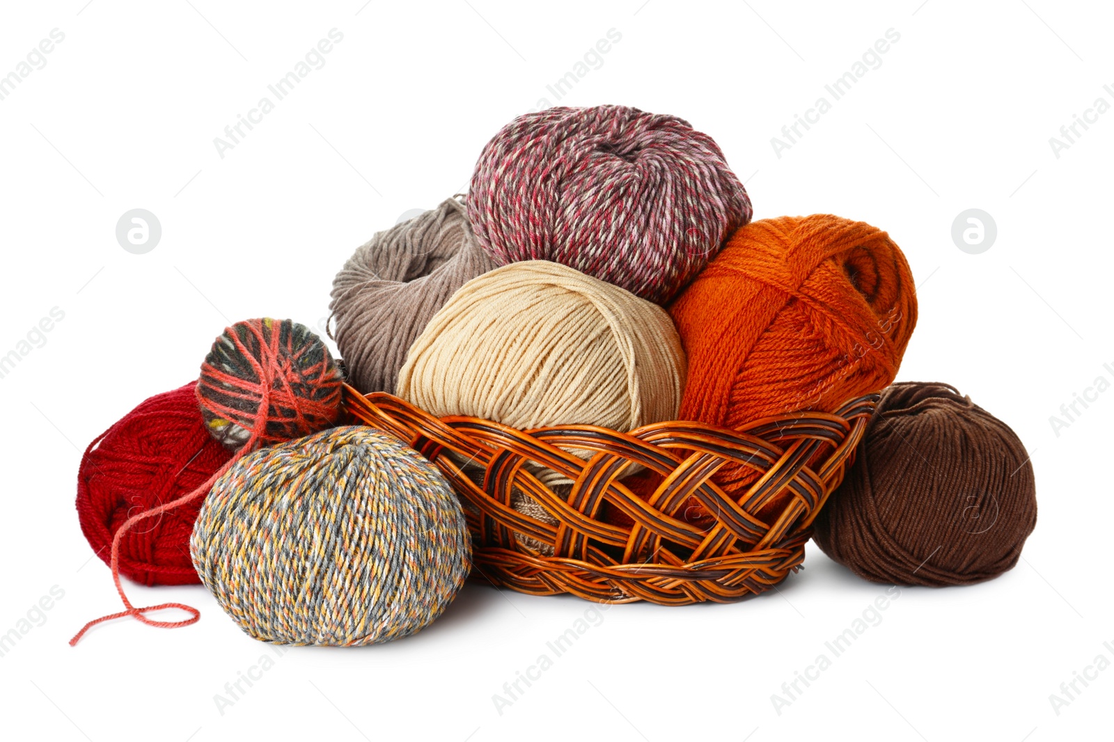 Photo of Wicker basket with different balls of woolen knitting yarns on white background